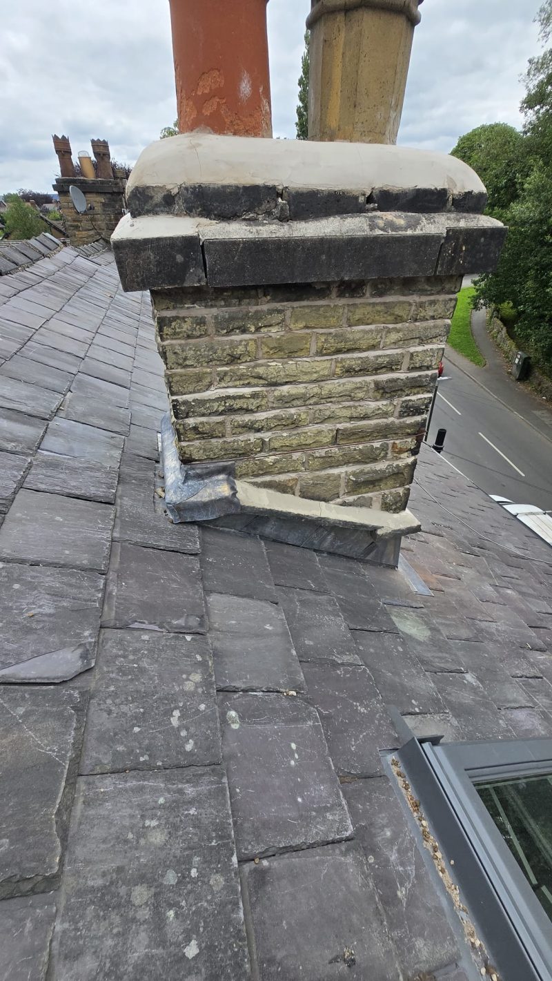 Repointed chimney stack with fresh lead flashing on a period roof