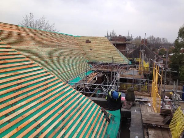 Re-roof in progress on a large property in Alderley Edge, with new battens and full scaffold