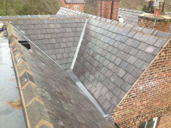 Natural slate re-roof with a hand-dressed lead valley between two pitches in Bollington