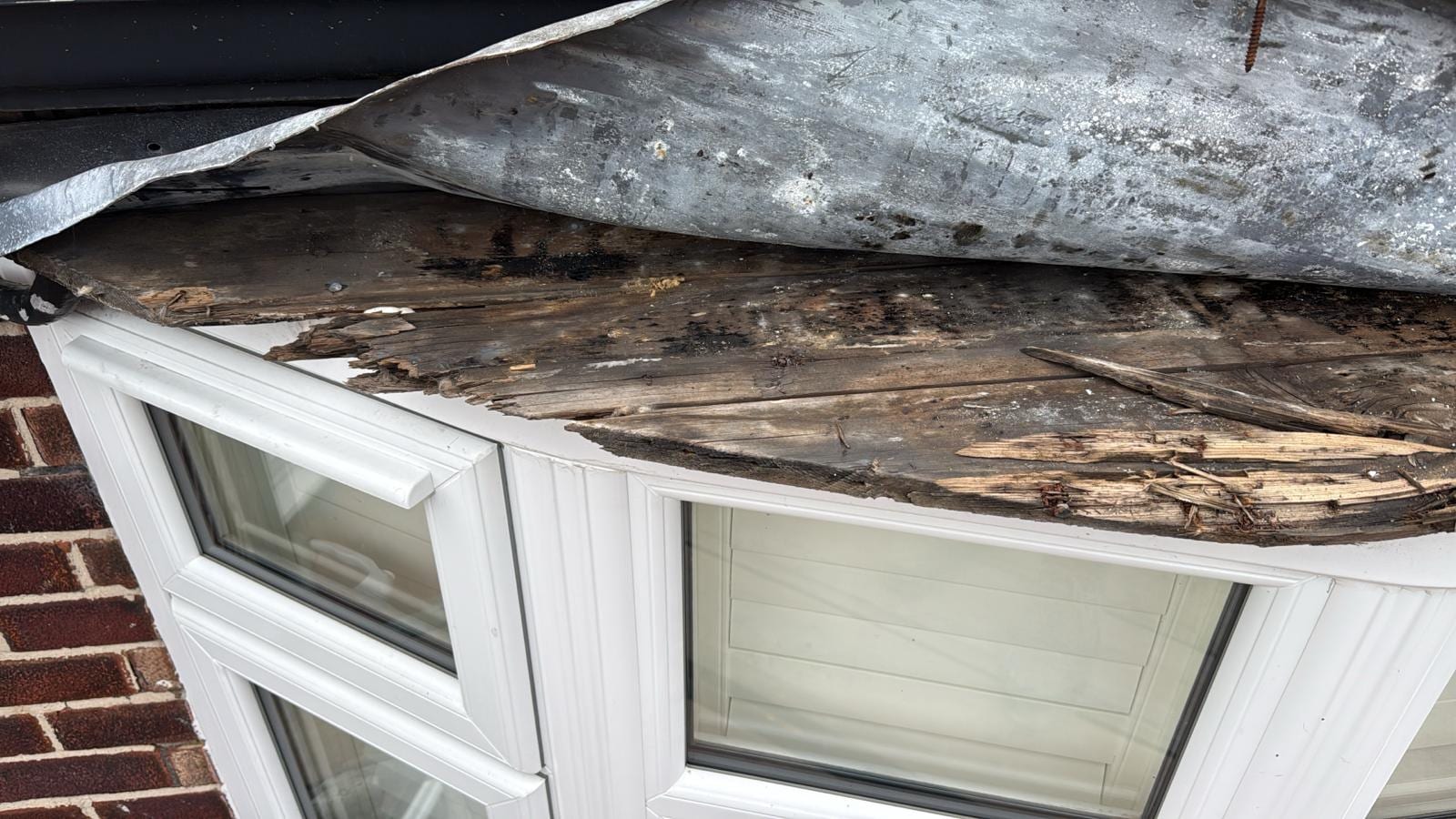 Lead bay window roof in Cheadle Hulme stripped back to expose rotten timber decking underneath the failed lead