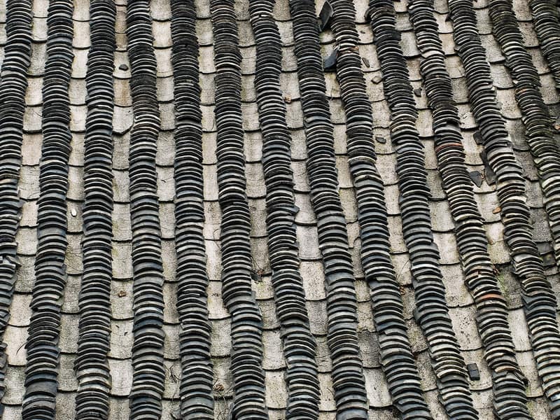 Clean grey slate roof tiles in neat overlapping rows