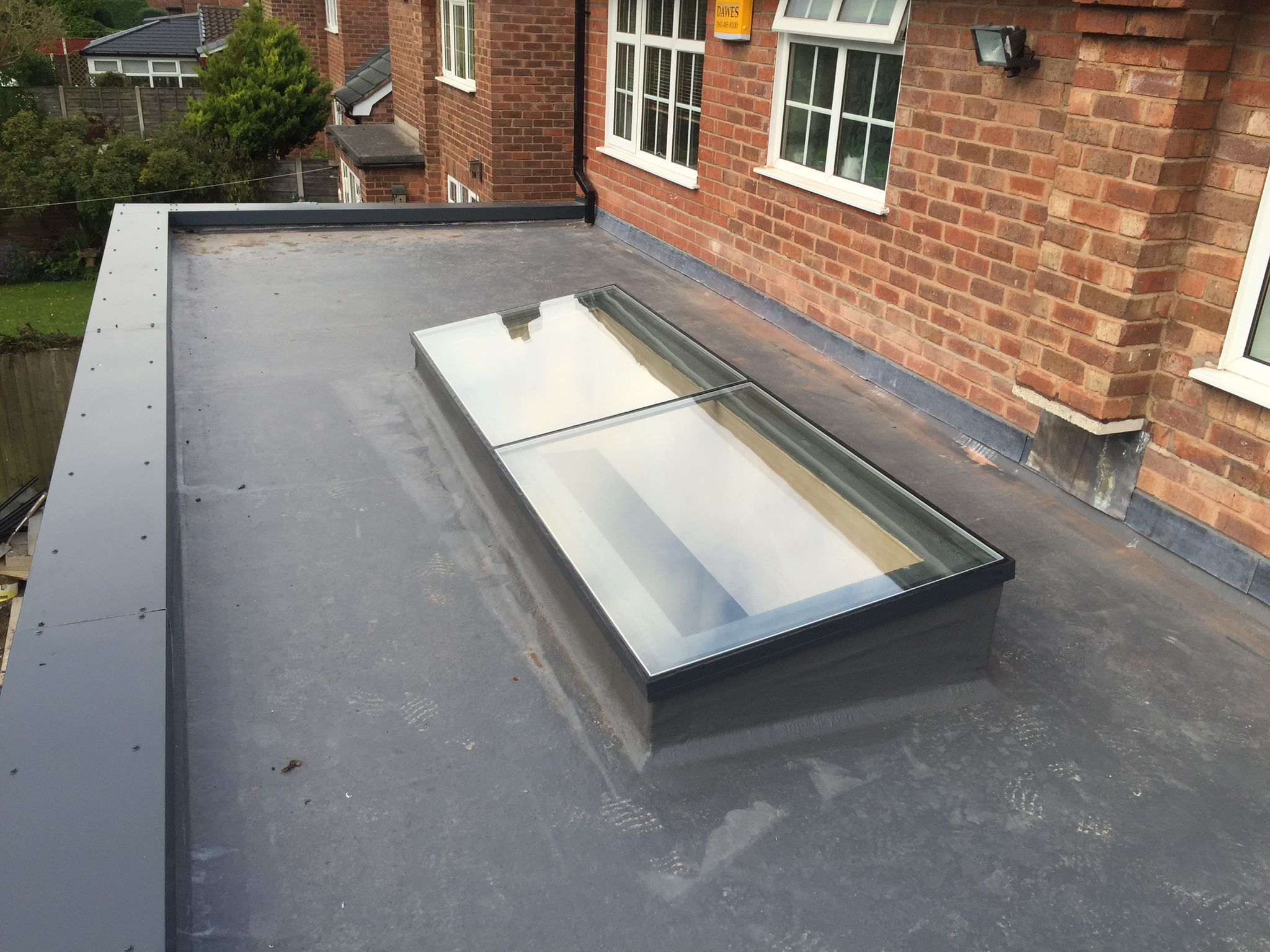 GRP fibreglass flat roof with integrated Velux skylight on a rear extension in Offerton