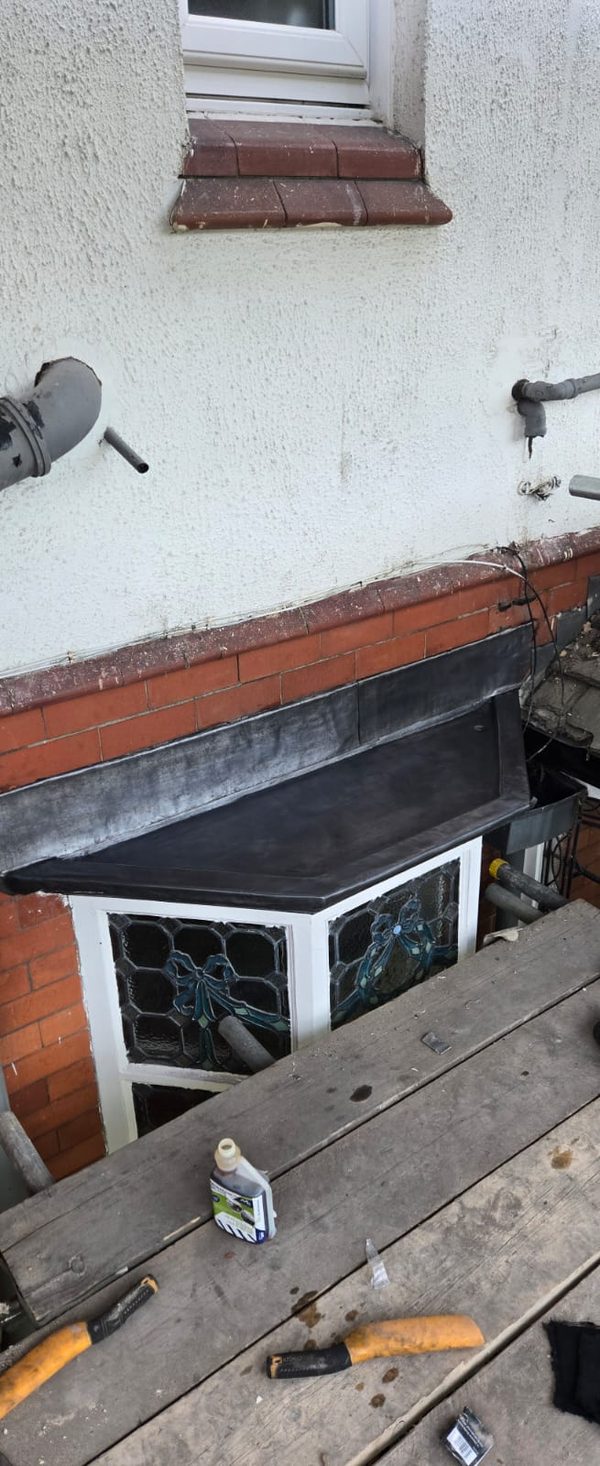 Hand-dressed lead flashing to a bay window roof on a period Bramhall home