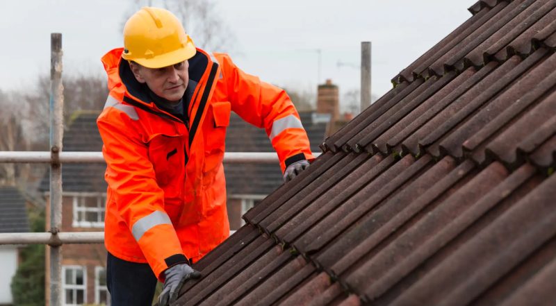 Independent roof surveyor inspecting a tiled pitched roof in Stockport, Daniel Scott Roofing partner NWRS