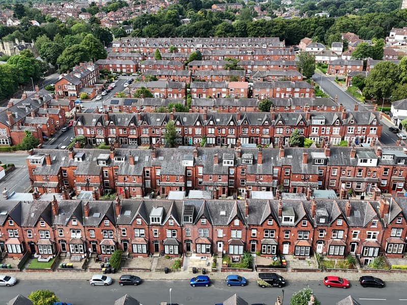 Rows of clean tiled roofs across terraced houses, free of moss